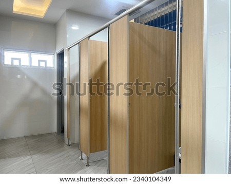 Row of public toilet decoration with wooden partition