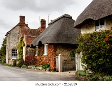 Row Of Quaint Cottages In A Rural Village Street In England