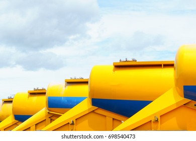 Row Of Rear Part Of The Truck Carrying Fly Ashes In Parking Area With Cloudy Blue Sky.