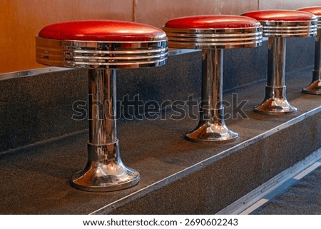 Row of red diner stools