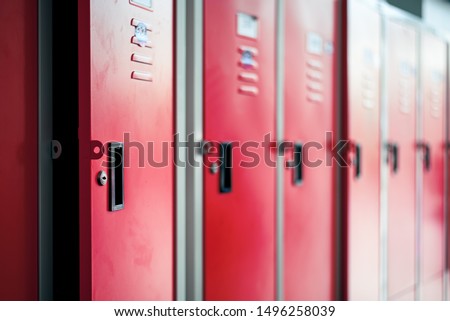 Row of red metal lockers in locker room