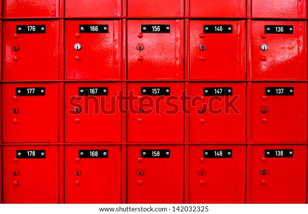 Row of red post-office PO boxes background. No\
people. Copy space