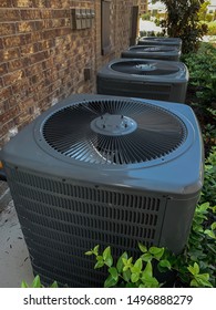 Row Of Residential HVAC Units Outside A Building.