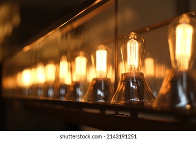 A Row Of Retro Light Bulbs At Night. Diminishing Perspective