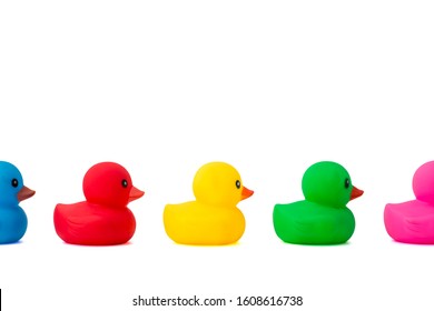 A Row Of Rubber Ducks On A White Background. Bright Colored Rubber Ducks In A Line. Rubber Ducks In A Row Isolated On A White Background.