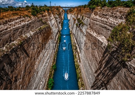 A row of sailing boats crossing through the Corinthian canal in Greece