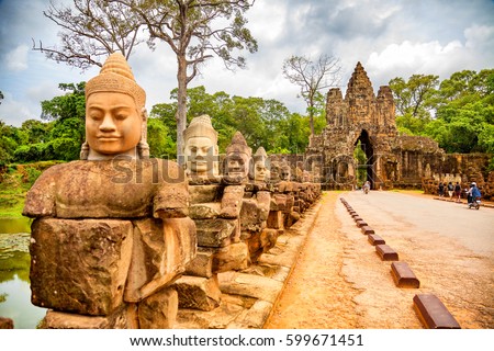 Row of sculptures in the South Gate of Angkor Thom complex. Siem Reap, Cambodia