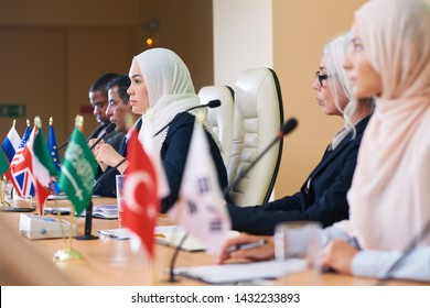 Row Of Serious Intercultural Delegates Listening Attentively