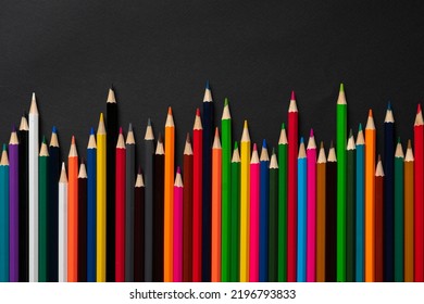 Row Of Set Of Colored Pencils Flat Lay On Pastel Background