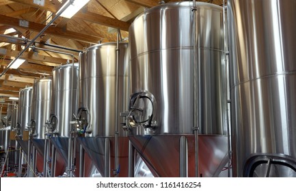 Row Of Shiny Metal Micro Brewery Tanks.