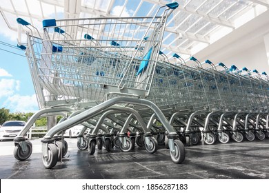 Row Of Shopping Cart In Front Of Supermarket Doorway For Customers Service, Empty Shopping Trolley In Front Of Convenience Grocery Store. Business Commodity Retail And Customer Market Place