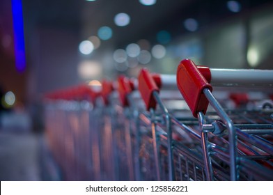 Row Of Shopping Carts On Winter Street At Evening Near Store