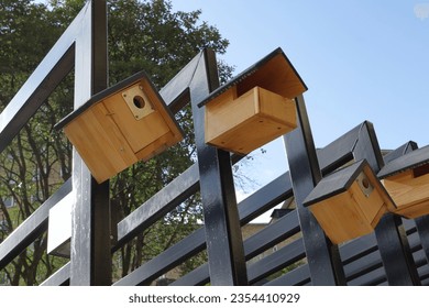 Row with small wooden birdhouses. 