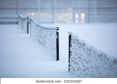 Row Of Snow Covered Tennis Court Nets, In A Weather Delay Concept, With Space For Text