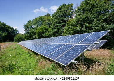 A Row Of Solar Panels Installed In A Rural Field In The United Kingdom