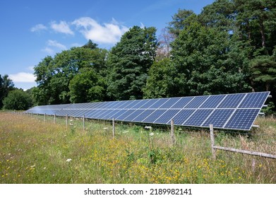 A Row Of Solar Panels Installed In A Rural Field In The United Kingdom