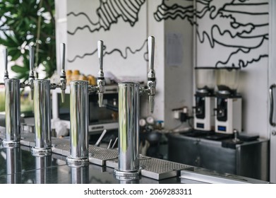 Row Of Stainless Draft Beer Dispenser On Counter Bar