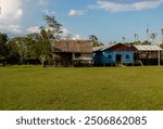 A row of stilt houses in Nauta, perched above the water of the Amazon Rrver, illustrating life in the Peruvian Amazon.