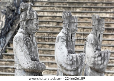 Row of stone mandarin statues in the tomb of Khai Dinh