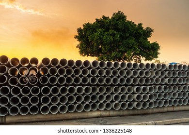 Row Of Storage Sewage Drainage Concrete Pipeline, Manufacturing Plant Of Material Construction, Stack Of Culvert Pipe And Water Treatment System.