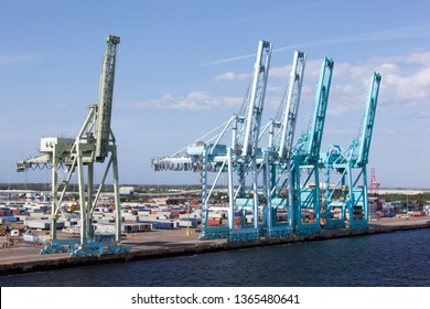 The Row Of Tall Cranes By St. Johns River In Jacksonville City Port (Florida).