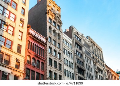 Row of tall historic buildings in the afternoon sunlight along Broadway in Manhattan, New York City NYC