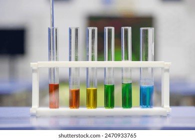 A row of test tubes with different colored liquids in them. The tubes are arranged in a row and are labeled with numbers. Concept of scientific experimentation and discovery - Powered by Shutterstock