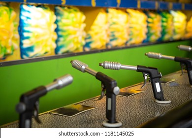 Row Of Toy Water Pistols For A Carnival Shooting Game, At A Boardwalk Midway, With Space For Text On Top