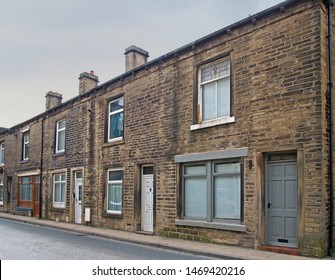 A Row Of Traditional English Old Working Class Terraced Houses On A Street With Grey Cloudy Sky