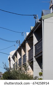 Row Of Traditional Terrace Houses In Australia With Power Lines Connecting To Central Source