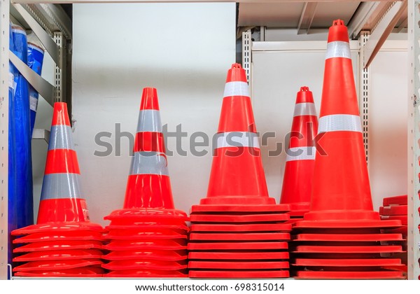 Row of Traffic safety cones ; road safety plastic\
cones on shelf