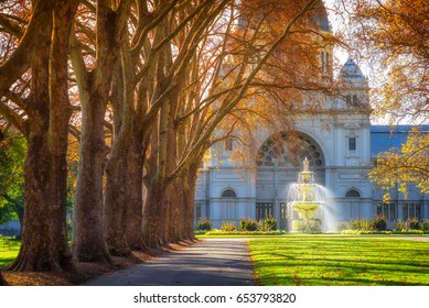A row of trees leading to a fountain in front of the Royal Exhibition Building at Carlton Gardens in Melbourne, Australia.