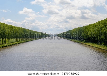 Row of trees on the side of the road along Amsterdam-Rhine canal (Amsterdam-Rijnkanaal) Connect the port and capital city of Amsterdam to the main shipping artery of the Rhine and Utrecht, Netherlands