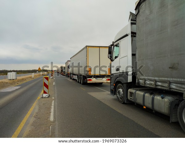 a row\
of trucks are in a traffic jam on the\
highway