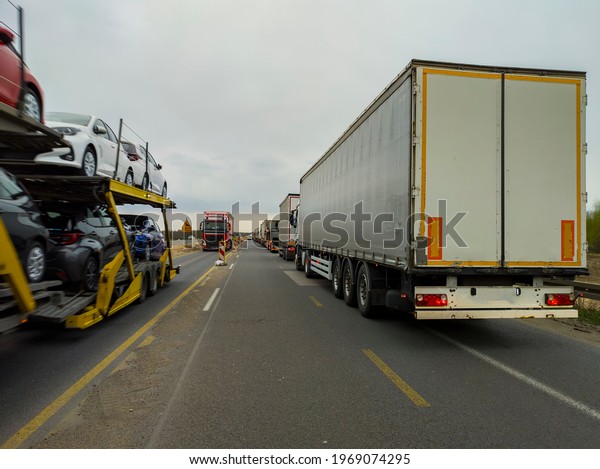 a row\
of trucks are in a traffic jam on the\
highway