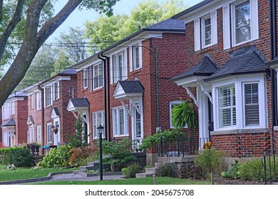 Row Of Uniform Semi-detached Houses In Middle Class Residential Neighborhood