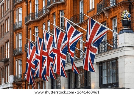 Row of Union Jack Flags Displayed on Classic London Building