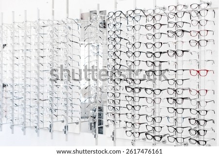 Row of various glasses and frames at an opticians shop. Stand with glasses in optics store