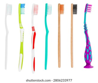 Row of various plastic and bamboo toothbrushes isolated on white background.