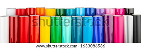 Row of various rainbow colored vinyl car wrapping or plotter cutting sticker foil film rolls isolated on white wide panorama banner background