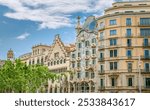 A row of vibrant buildings in Barcelona, featuring the iconic Casa Batllo by Antoni Gaudi