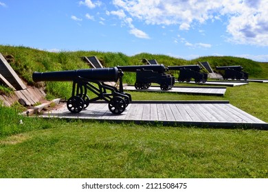Row of vintage cannons on display at Victoria Park on sunny day during Summer
