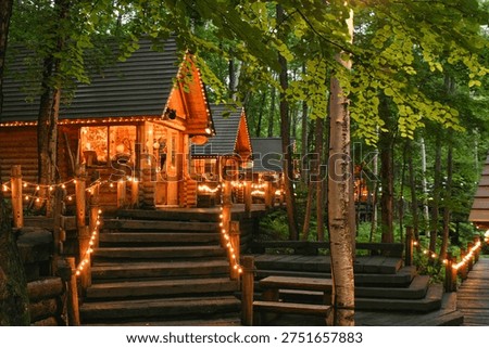 A row of warm, inviting log cabins nestled in the forests of Furano.
Soft lights glow through the trees, creating a peaceful atmosphere that feels like stepping into a quiet storybook moment.