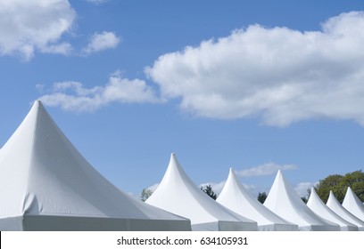 Row Of White Canvas Event Tents Against Blue Sky, Party Tents At The Park