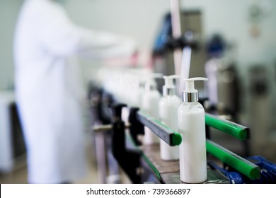 Row of white cosmetics on the conveyor line.