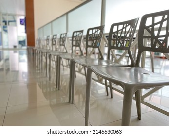 Row Of White Empty Chairs In Waiting Area Of Car Repair Shop