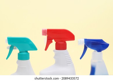 Row Of White Plastic Bottle With Spray And Foam Nozzle On Yellow Background    