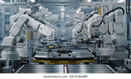 Row of White Robotic Arms at Modern Factory. Lithium-Ion EV Battery Pack Production at Automated Assembly Line at Bright Factory Equipped With Industrial Robot Arms. Electric Car Manufacturing. 