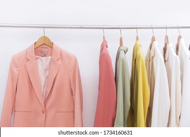 Row Of Woman Fashion Clothes Of Different Colors Clothing On Hangers, Hanging Clothes Suit Colorful Or Closet Rack


