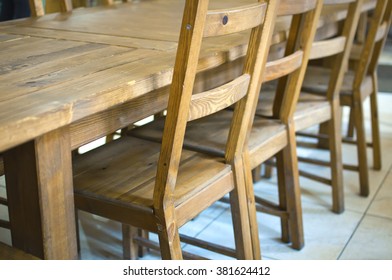 Row of wooden chairs at the table in the interior of a cafe